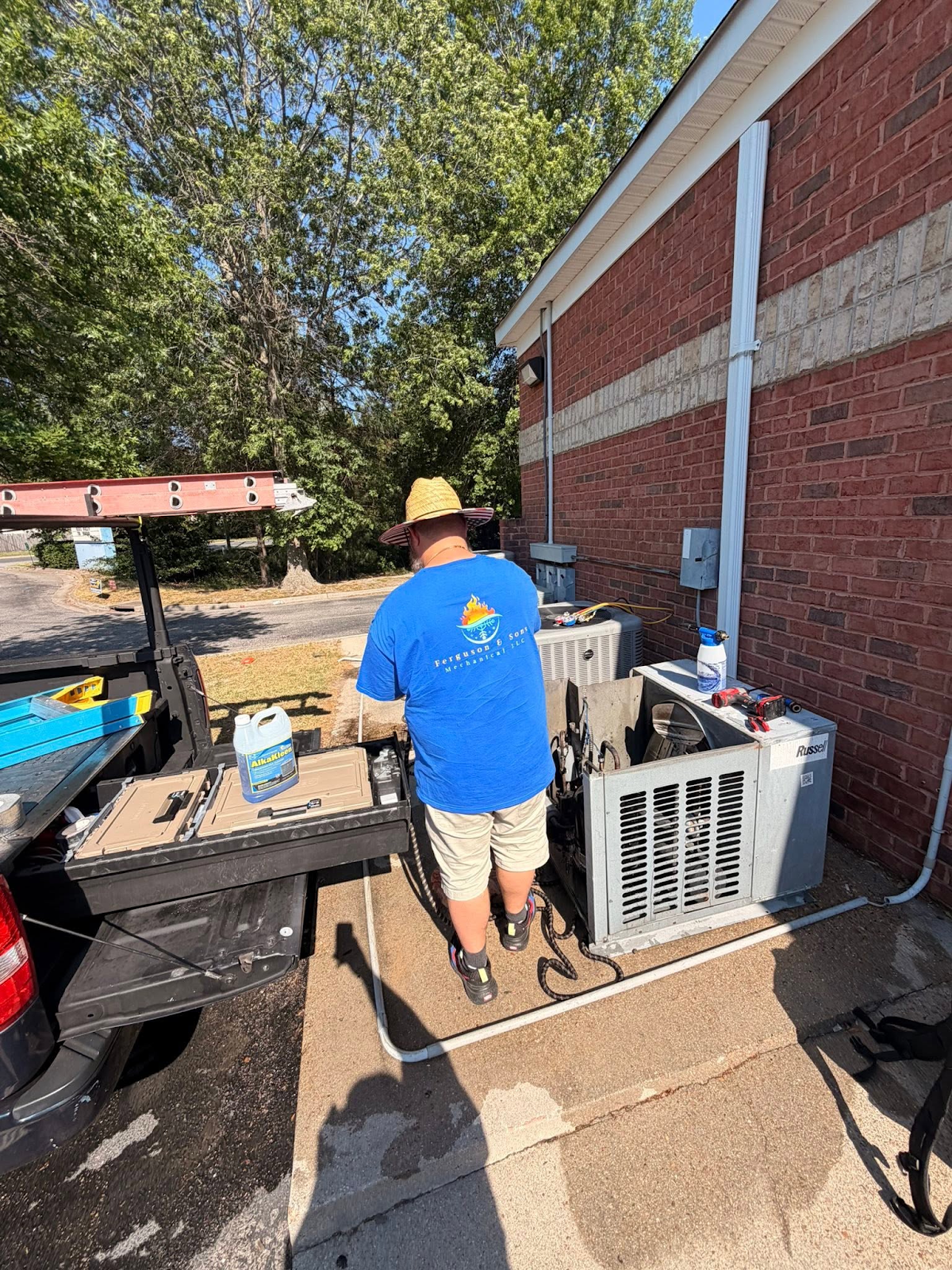 Ferguson & Sons technician working beside a building