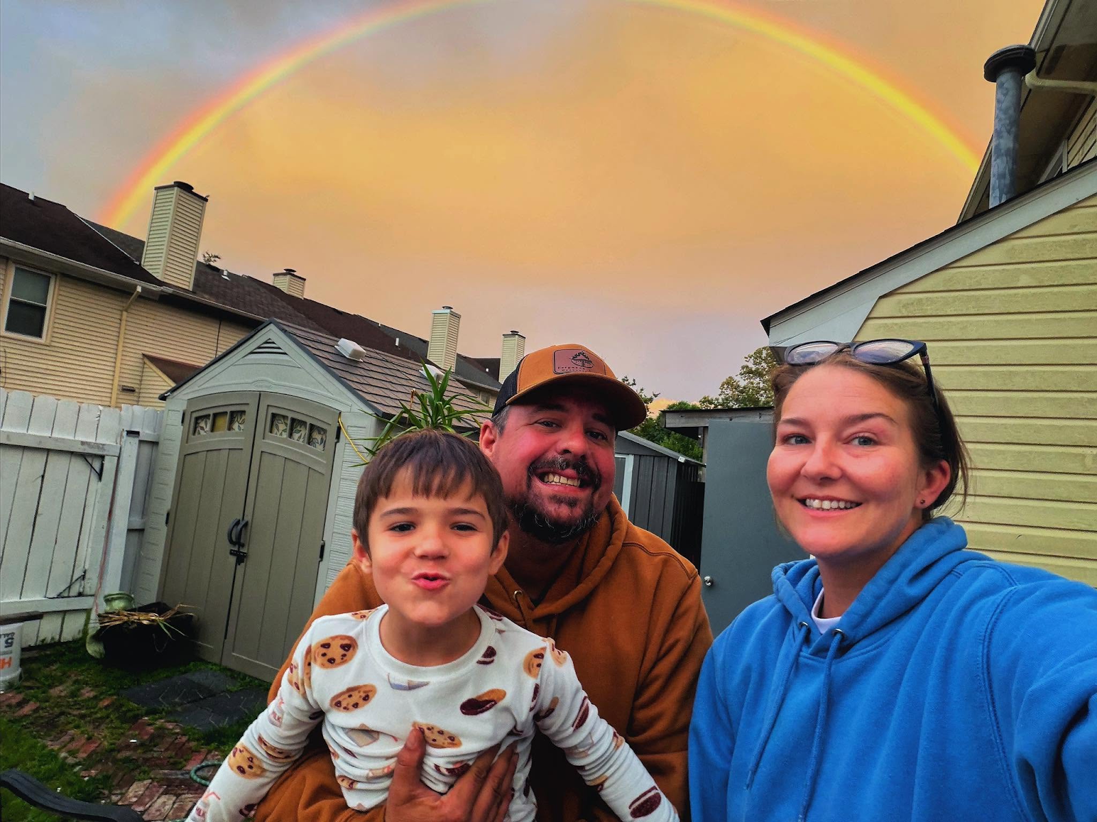 The Ferguson family together beneath a rainbow